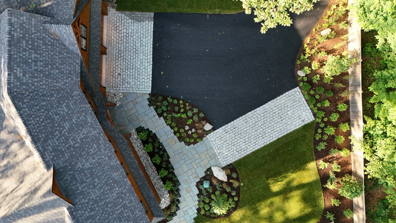 Aerial view of completed cobblestone walkways and landscaping by Black Bear Stoneworks
