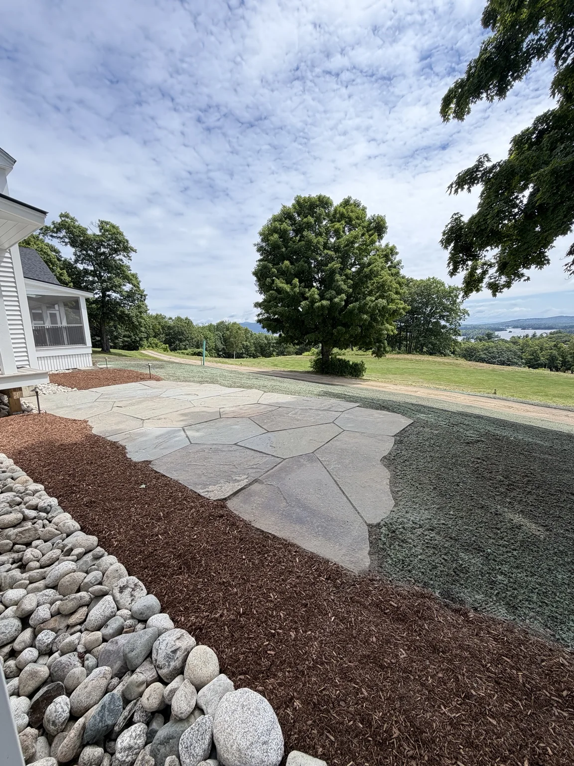 Natural stone patio overlooking a New Hampshire landscape